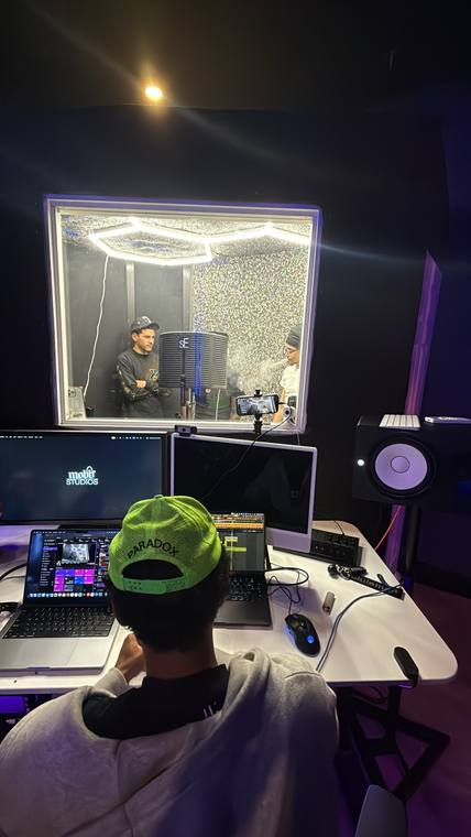 Engineer at the desk watching the booth
