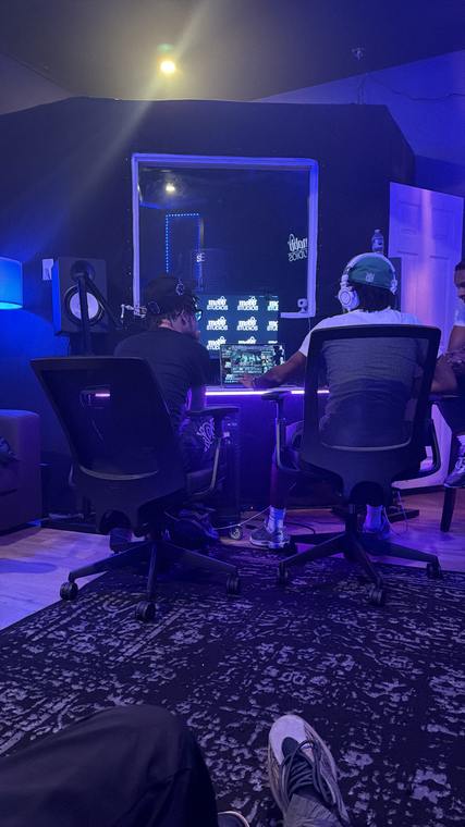 Two engineers working at the desk under blue light