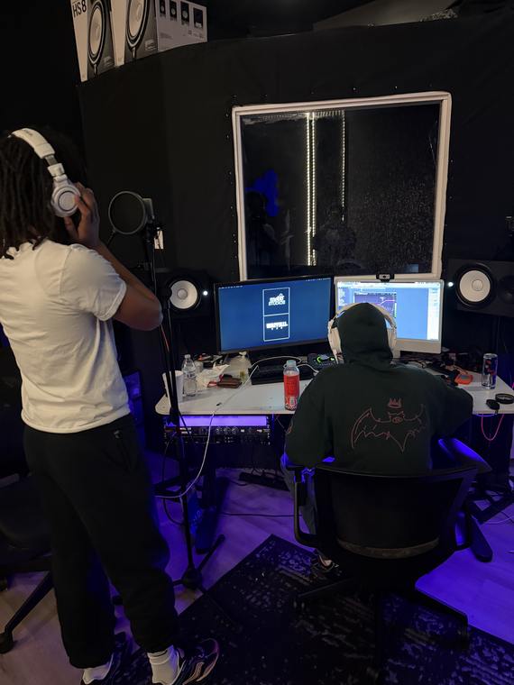 Artist at the mic while the engineer runs the session