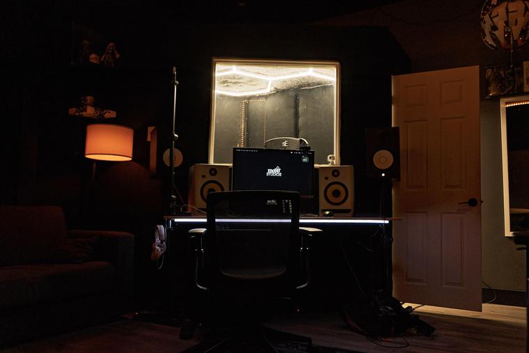 Room A control desk, monitors and vocal booth window