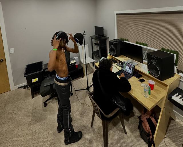 Tracking vocals with an engineer at the desk
