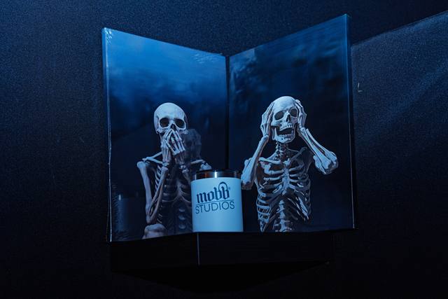 Skeleton art print beside a Mobb Studios mug